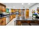 Bright kitchen with stainless steel appliances, wooden cabinetry, granite countertops, and a breakfast bar with seating at 2066 E Lockwood St, Mesa, AZ 85213
