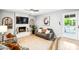Bright living room with fireplace, neutral sofa, with access to a door leading to the backyard pool at 2066 E Lockwood St, Mesa, AZ 85213