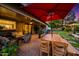 Inviting covered patio featuring comfortable seating, a dining area, and lush landscaping at 2066 E Lockwood St, Mesa, AZ 85213
