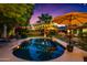 Stunning pool reflecting the evening sky, surrounded by manicured landscaping and inviting outdoor spaces at 2066 E Lockwood St, Mesa, AZ 85213