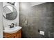 Small powder room with gray wallpaper, a white sink and toilet paper holder at 2066 E Lockwood St, Mesa, AZ 85213