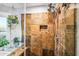 Walk-in shower features natural stone tile, a rainfall showerhead, and a built-in niche at 2066 E Lockwood St, Mesa, AZ 85213