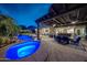 Covered patio and sparkling pool with lush landscaping creating a backyard oasis for relaxation and entertaining at 20791 W Main St, Buckeye, AZ 85396