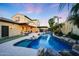 Private backyard with a stunning pool, water feature, and covered patio area, perfect for entertaining at 20791 W Main St, Buckeye, AZ 85396