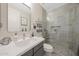 Bright bathroom featuring a white vanity, modern fixtures, and a walk-in shower with decorative tile and pebble flooring at 20791 W Main St, Buckeye, AZ 85396