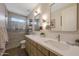 Modern bathroom featuring double sinks, quartz counters, and a glass-enclosed shower at 20791 W Main St, Buckeye, AZ 85396
