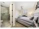 Bright bedroom with a walk-in shower, sliding closet doors, and neutral carpet creating an inviting space at 20791 W Main St, Buckeye, AZ 85396
