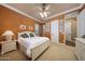 Bright bedroom featuring a king bed, and warm paint, and light carpet, creating a cozy and inviting atmosphere at 20791 W Main St, Buckeye, AZ 85396