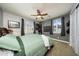 Comfortable bedroom with a ceiling fan, shutters, with neutral walls, providing a relaxing space at 20791 W Main St, Buckeye, AZ 85396