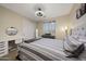 Bright bedroom with a modern desk, sliding closet doors, and neutral walls and carpet creating a serene space at 20791 W Main St, Buckeye, AZ 85396