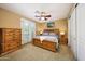 Cozy bedroom with a wooden furniture set, shutters, and a walkout balcony, creates a tranquil retreat at 20791 W Main St, Buckeye, AZ 85396