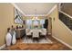 Dining room with a contemporary chandelier, shuttered windows, and stylish artwork at 20791 W Main St, Buckeye, AZ 85396