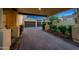Paver driveway leading to a three-car garage, surrounded by manicured landscaping at 20791 W Main St, Buckeye, AZ 85396