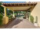Mediterranean driveway with brick pavers, pergola, and lush landscaping leading to a beautiful home at 20791 W Main St, Buckeye, AZ 85396