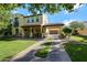 Inviting front exterior with covered porch, manicured lawn, and porte-cochere at 20791 W Main St, Buckeye, AZ 85396