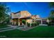Beautiful two-story home with a tile roof, covered porch, and well-manicured lawn and landscaping at 20791 W Main St, Buckeye, AZ 85396
