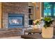 Living room features a stone fireplace, built-in shelves, and view of the outside at 20791 W Main St, Buckeye, AZ 85396