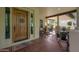 Relaxing front porch with a comfortable seating area and stylish wood front door at 20791 W Main St, Buckeye, AZ 85396