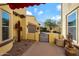 Inviting front yard featuring desert landscaping, a decorative gate, and access to the garage at 20791 W Main St, Buckeye, AZ 85396