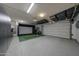 View of organized garage featuring a golf simulator, storage, and durable epoxy flooring at 20791 W Main St, Buckeye, AZ 85396