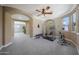 Large bonus room featuring exercise equipment, neutral carpet, stylish light fixture, and elegant architectural details at 20791 W Main St, Buckeye, AZ 85396