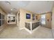 Spacious hallway with carpet, light walls, and iron railing, connecting various rooms of the house at 20791 W Main St, Buckeye, AZ 85396