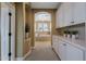 Hallway view of soaking tub with tile surround, hall storage, and neutral color palette at 20791 W Main St, Buckeye, AZ 85396