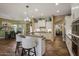 Gourmet kitchen with a large island and bar seating adjacent to the dining area at 20791 W Main St, Buckeye, AZ 85396