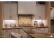 Gourmet kitchen featuring white cabinets, granite countertops, and stainless steel appliances at 20791 W Main St, Buckeye, AZ 85396