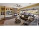 Spacious living room with stone fireplace, built-in shelving, large leather sofa, and access to outdoor patio at 20791 W Main St, Buckeye, AZ 85396