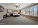Spacious main bedroom with plush carpeting, plantation shutters, sitting area, and natural light at 20791 W Main St, Buckeye, AZ 85396