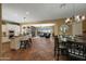 Bright, open-concept living space with a large kitchen, dining area, and comfortable living room with fireplace at 20791 W Main St, Buckeye, AZ 85396