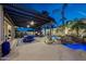 Relaxing outdoor patio with pergola, dining area, spa, and tranquil waterfall feature at 20791 W Main St, Buckeye, AZ 85396