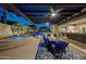 Covered outdoor patio with ceiling fans, dining area, and seamless transition to indoor living space at 20791 W Main St, Buckeye, AZ 85396