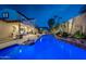 Stunning backyard pool and spa featuring lush tropical landscaping and a covered outdoor living area at 20791 W Main St, Buckeye, AZ 85396