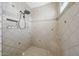 Modern shower features neutral tile, recessed storage, shower seat, and glass block accents at 20791 W Main St, Buckeye, AZ 85396