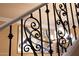 Detailed close-up of staircase wrought iron with view of dining room chandelier at 20791 W Main St, Buckeye, AZ 85396