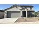 Charming two-story home featuring a neutral color scheme, landscaped front yard, and a two-car garage at 25348 W Bowker St, Buckeye, AZ 85326