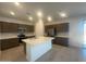 Modern kitchen featuring a central island, stainless steel appliances, and sleek cabinetry at 25348 W Bowker St, Buckeye, AZ 85326