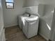 Functional laundry room with a window, tiled floors, washer, and dryer for convenient chores at 25348 W Bowker St, Buckeye, AZ 85326