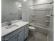 Bathroom featuring white cabinets, white countertop and a bathtub with white tile surround at 25354 W Bowker St, Buckeye, AZ 85326