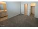 Spacious carpeted bedroom with ensuite bathroom and walk-in closet at 25354 W Bowker St, Buckeye, AZ 85326