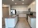 Well-lit kitchen with white cabinets, granite counters, stainless appliances and a kitchen island at 25354 W Bowker St, Buckeye, AZ 85326