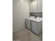 Laundry room with modern appliances and white cabinets at 25354 W Bowker St, Buckeye, AZ 85326