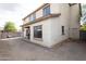 View of backyard of a two-story home with a covered patio and gravel groundcover at 2749 S Powell Rd, Apache Junction, AZ 85119