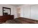 View of a bedroom featuring a dresser with a mirror and a bed with brown bedding at 2749 S Powell Rd, Apache Junction, AZ 85119