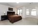 Relaxing bedroom featuring a king bed, side tables, art and an adjacent door to an outside patio at 2749 S Powell Rd, Apache Junction, AZ 85119