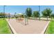 Community playground with modern metal and plastic equipment with a background of trees at 2749 S Powell Rd, Apache Junction, AZ 85119