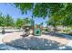 Community playground with a slide and other climbing structures shaded by mature landscaping at 2749 S Powell Rd, Apache Junction, AZ 85119