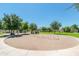 Community playground featuring swings, mature trees and ample space for activities at 2749 S Powell Rd, Apache Junction, AZ 85119